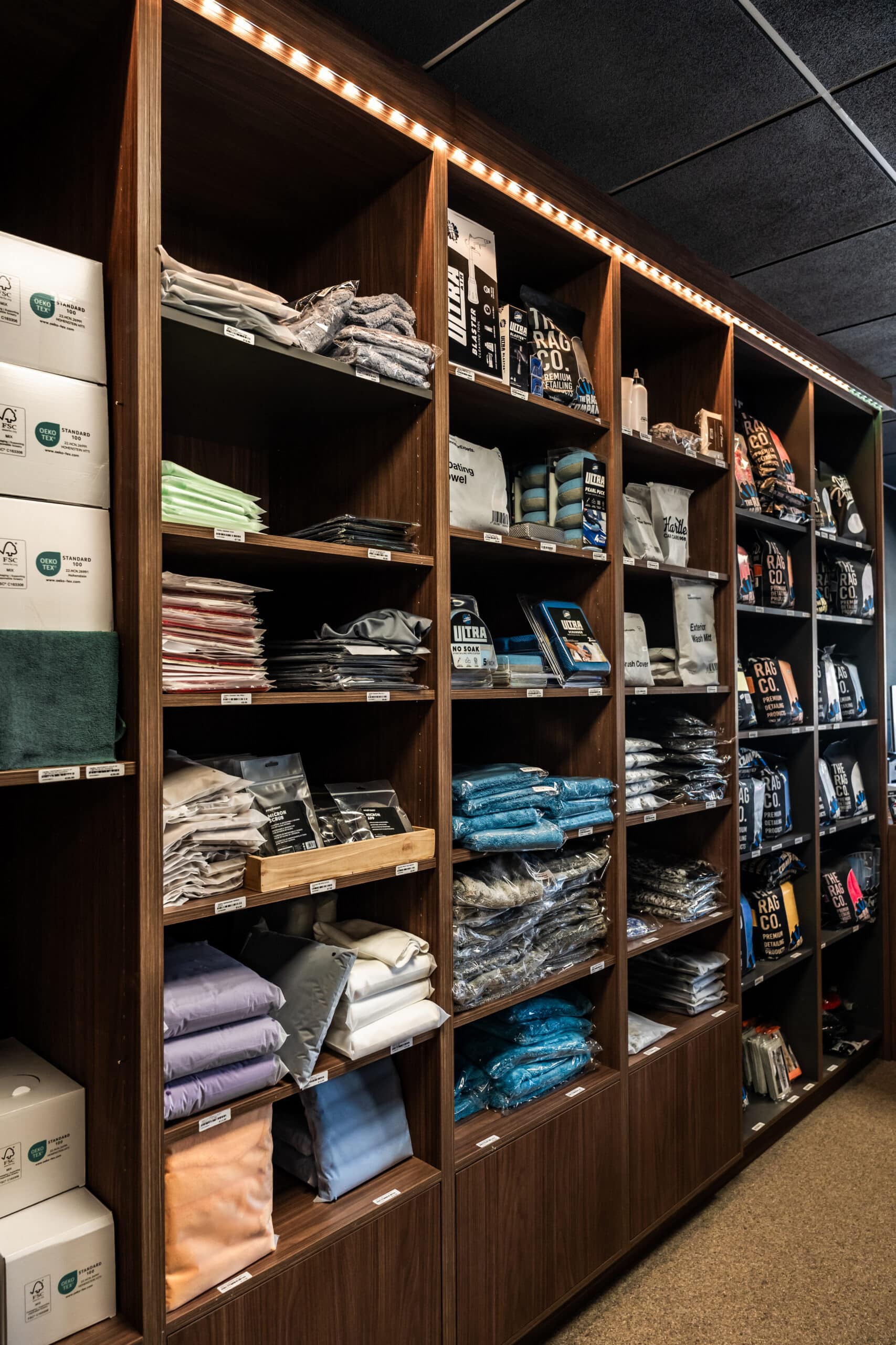 Schappen met microvezeldoeken en accessoires in de Hartley Car Care winkel